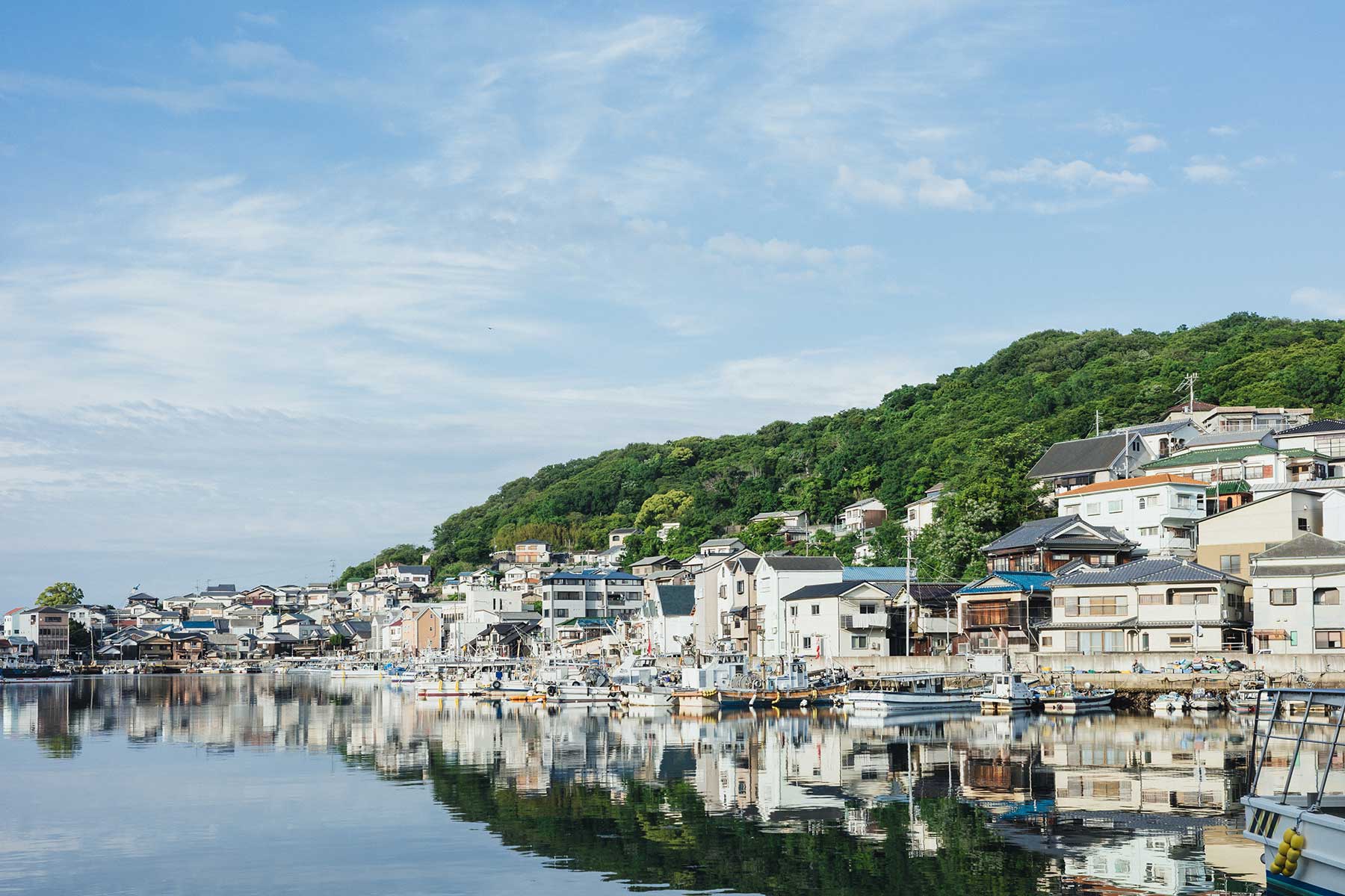 A narrow street between empty houses in the Miya district